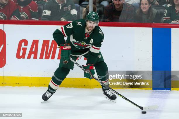 Marcus Foligno of the Minnesota Wild skates with the puck against the San Jose Sharks in the third period of the game at Xcel Energy Center on April...