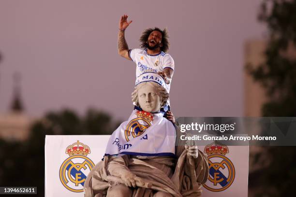 Marcelo of Real Madrid celebrates on top of the fountain at Plaza de Cibeles following their victory in their LaLiga match against RCD Espanyol which...