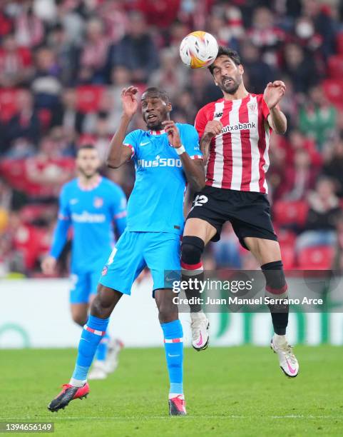 Raul Garcia of Athletic Bilbao wins a header before Geoffrey Kondogbia of Atletico Madrid during the LaLiga Santander match between Athletic Club and...