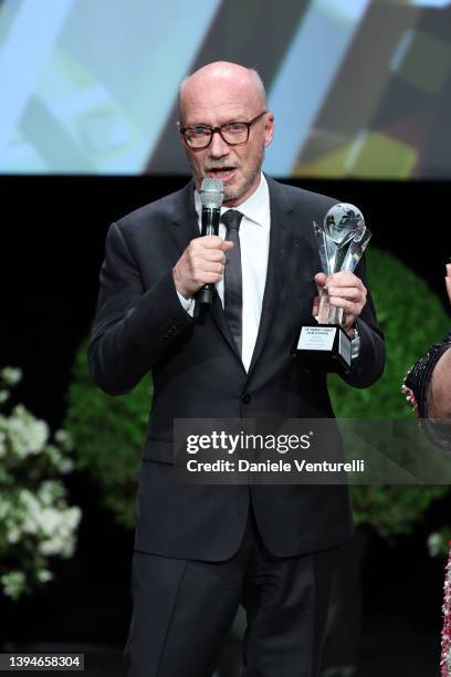 Paul Haggis receives an award during the 19th Monte-Carlo Film Festival De La Comedie at Grimaldi Forum on April 30, 2022 in Monaco, Monaco.