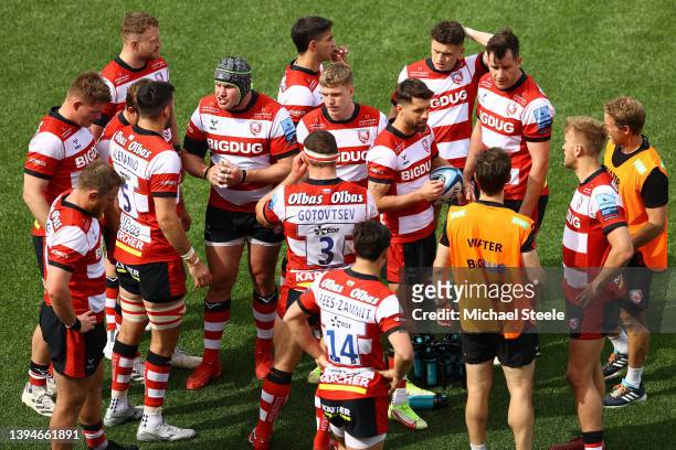 Adam Hastings of Gloucester holds the ball as the players of Gloucester gather during the Gallagher Premiership Rugby match between Gloucester Rugby...