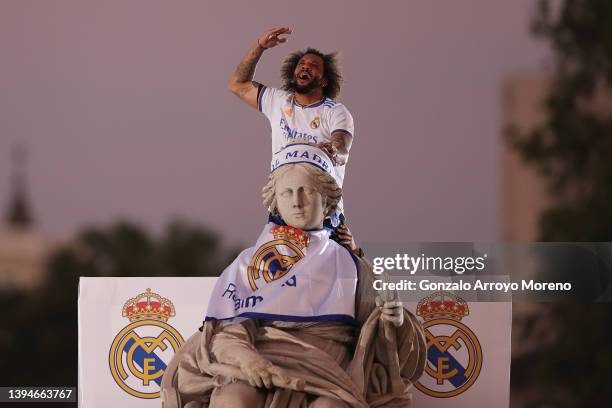 Marcelo of Real Madrid celebrates on top of the fountain at Plaza de Cibeles following their victory in their LaLiga match against RCD Espanyol which...