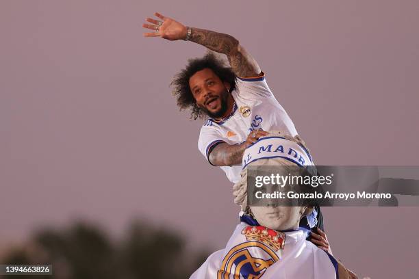 Marcelo of Real Madrid celebrates on top of the fountain at Plaza de Cibeles following their victory in their LaLiga match against RCD Espanyol which...