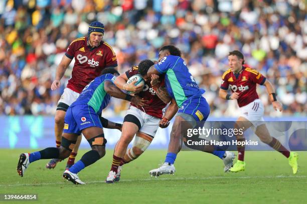 Jermaine Ainsley of the Highlanders is tackled during the round 11 Super Rugby Pacific match between the Fijian Drua and the Highlanders at ANZ...