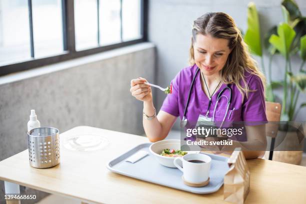 nurse using digital banking - workplace canteen lunch stock pictures, royalty-free photos & images