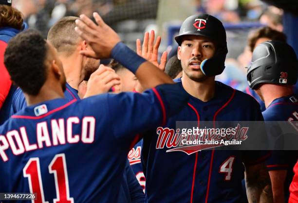 Carlos Correa of the Minnesota Twins celebrates with Jorge Polanco after scoring in the sixth inning against the Tampa Bay Rays at Tropicana Field on...