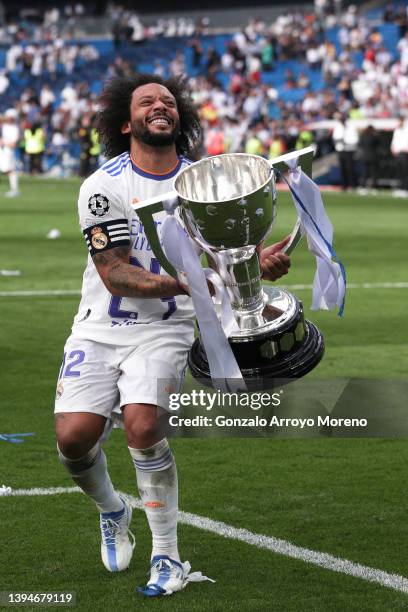 Marcelo of Real Madrid CF rises the La Liga trophy as he celebrates following their side's victory in the LaLiga Santander match between Real Madrid...