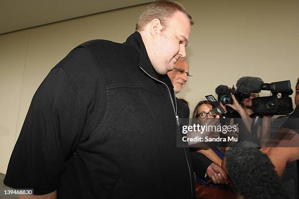 Kim Dotcom walks through a group of media after being released on bail at North Shore District Court on February 22, 2012 in Auckland, New Zealand....