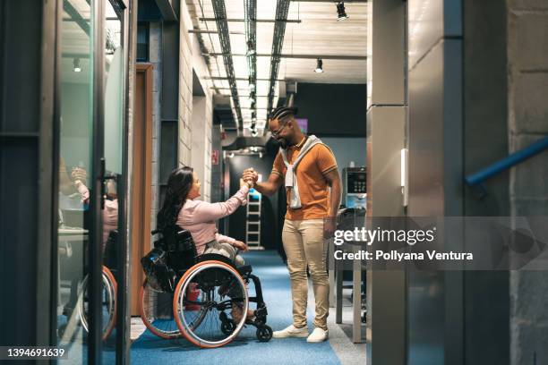 employees shaking hands - disability working stockfoto's en -beelden
