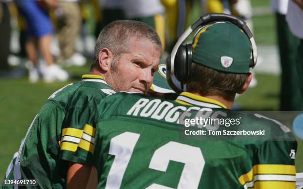 Brett Favre of the Green Bay Packers talks to backup quarterback Aaron Rodgers on the bench during NFL game action against the New Orleans Saints at...