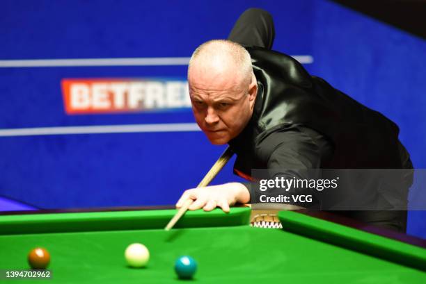 John Higgins of Scotland plays a shot during the semi-final match against Ronnie O'Sullivan of England on day 15 of the Betfred World Snooker...