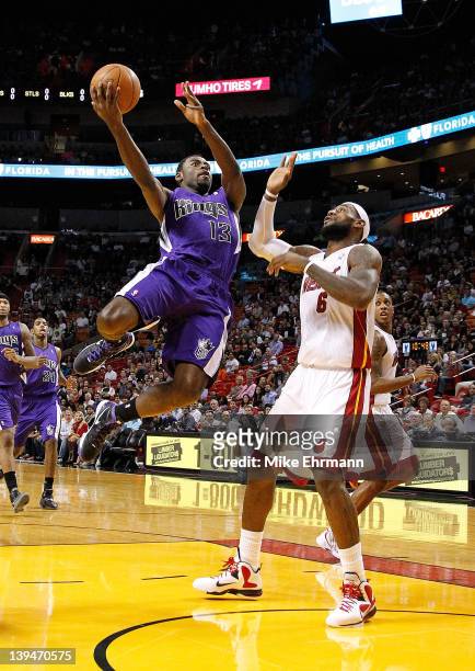 Tyreke Evans of the Sacramento Kings shoots over LeBron James of the Miami Heat during a game at American Airlines Arena on February 21, 2012 in...