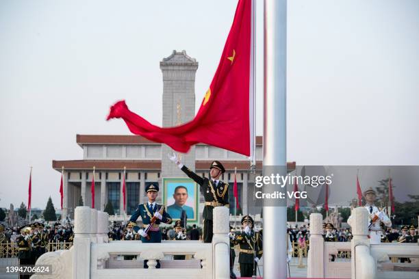 The Guard of Honor of the Chinese People's Liberation Army perform a flag-raising ceremony at the Tian'anmen Square to celebrate the International...