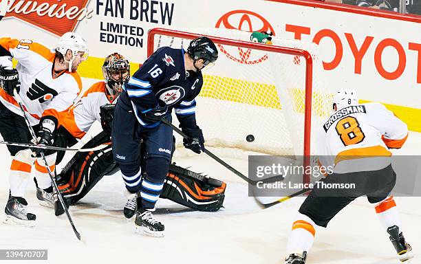 Andrej Meszaros, goaltender Ilya Bryzgalov and Nicklas Grossman of the Philadelphia Flyers can only watch as Andrew Ladd of the Winnipeg Jets...