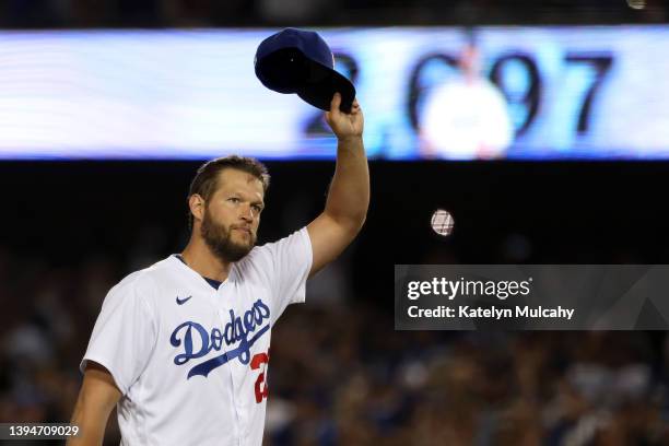 Clayton Kershaw of the Los Angeles Dodgers raises his hat to acknowledge the crowd after becoming the Los Angeles Dodgers All-Time Strikeout Leader...