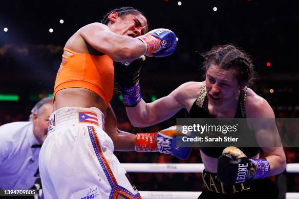 Katie Taylor of Ireland trades punches with Amanda Serrano of Puerto Rico for the World Lightweight Title fight at Madison Square Garden on April 30,...