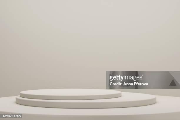 minimalist beige podiums on beige background. perfect place for your products presentation. three dimensional illustration - podio del vincitore foto e immagini stock