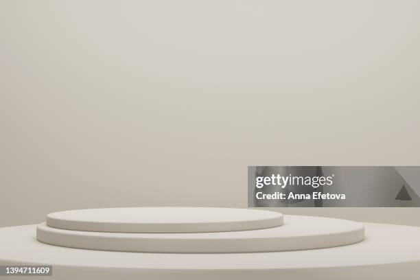 minimalist beige podiums on beige background. perfect place for your products presentation. three dimensional illustration - retail display - fotografias e filmes do acervo