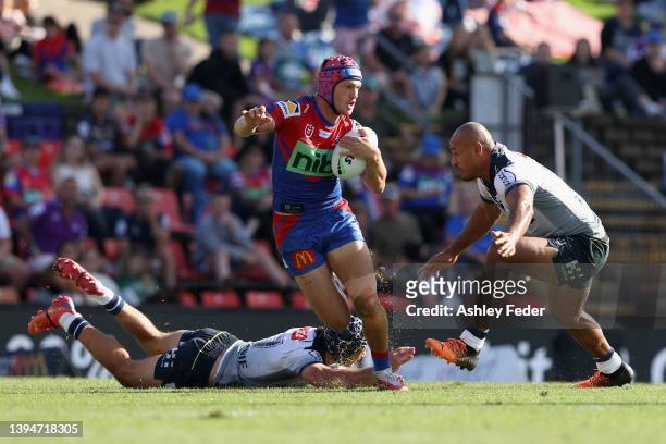 Kalyn Ponga of the Knights is tackled by the Storm during the round eight NRL match between the Newcastle Knights and the Melbourne Storm at McDonald...