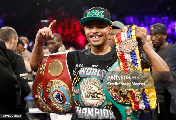 Junior lightweight champion Shakur Stevenson poses with belts after defeating WBC champion Oscar Valdez in a title unification fight at MGM Grand...