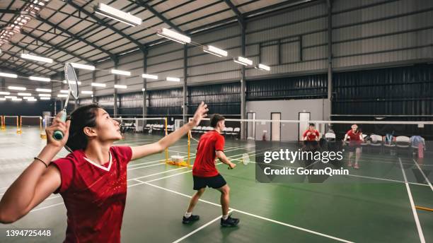 《badminton spirit》smash during the match - badminton smash stock pictures, royalty-free photos & images