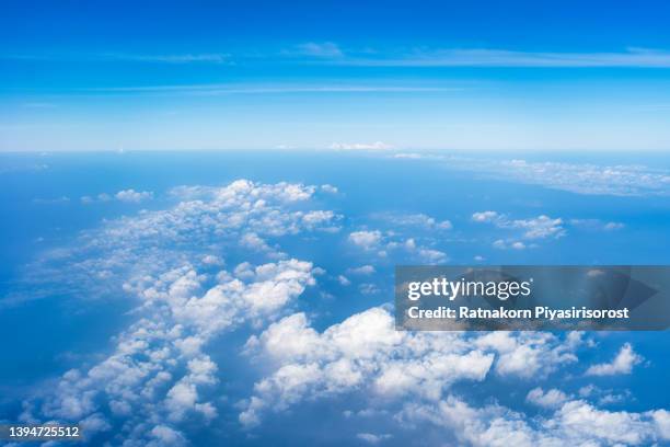 sea of clouds above the stratosphere view from airplane window - airplane window exterior stock-fotos und bilder