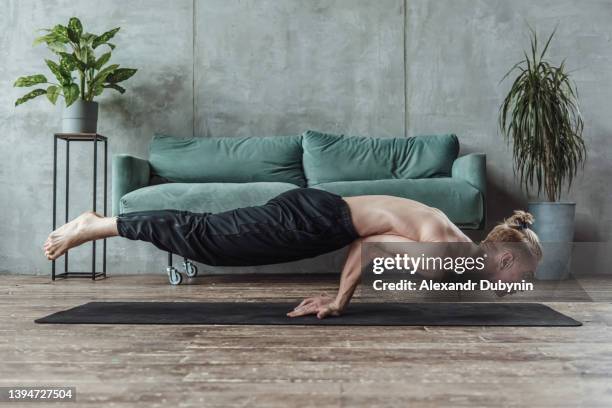 yogi man standing on his hands in the morning meditating doing yoga exercises - handstand fotografías e imágenes de stock