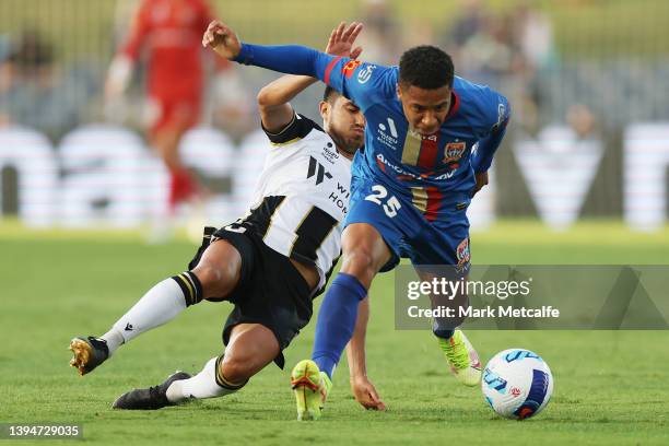 Samuel Silvera of the Jets Is tackled by Ulises Davila of the Bulls during the A-League mens match between Macarthur FC and Newcastle Jets at...