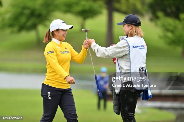 Mao Saigo of Japan fist bumps with Anna Kono, acts as her caddie after winning the tournament on the 18th green during the final round of Panasonic...