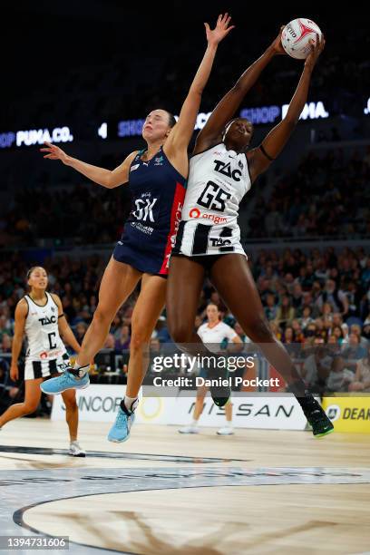 Shimona Nelson of the Magpies receives a pass under pressure from Olivia Lewis of the Vixens during the round seven Super Netball match between...