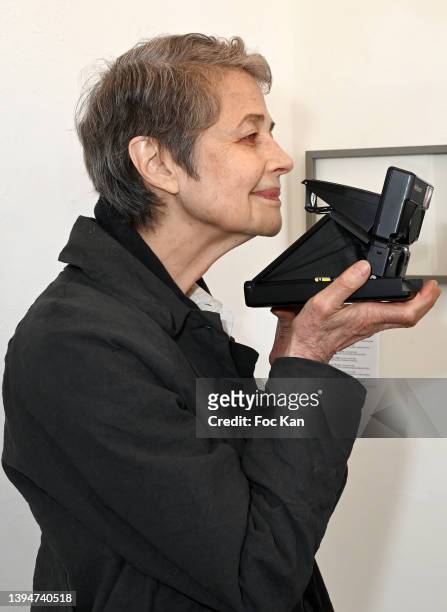 Actress Charlotte Rampling tries a vintage eighties Polaroid camera during "Avant La Pose" Marianne Rosenstiehl’s Polaroid Exhibition Preview At...