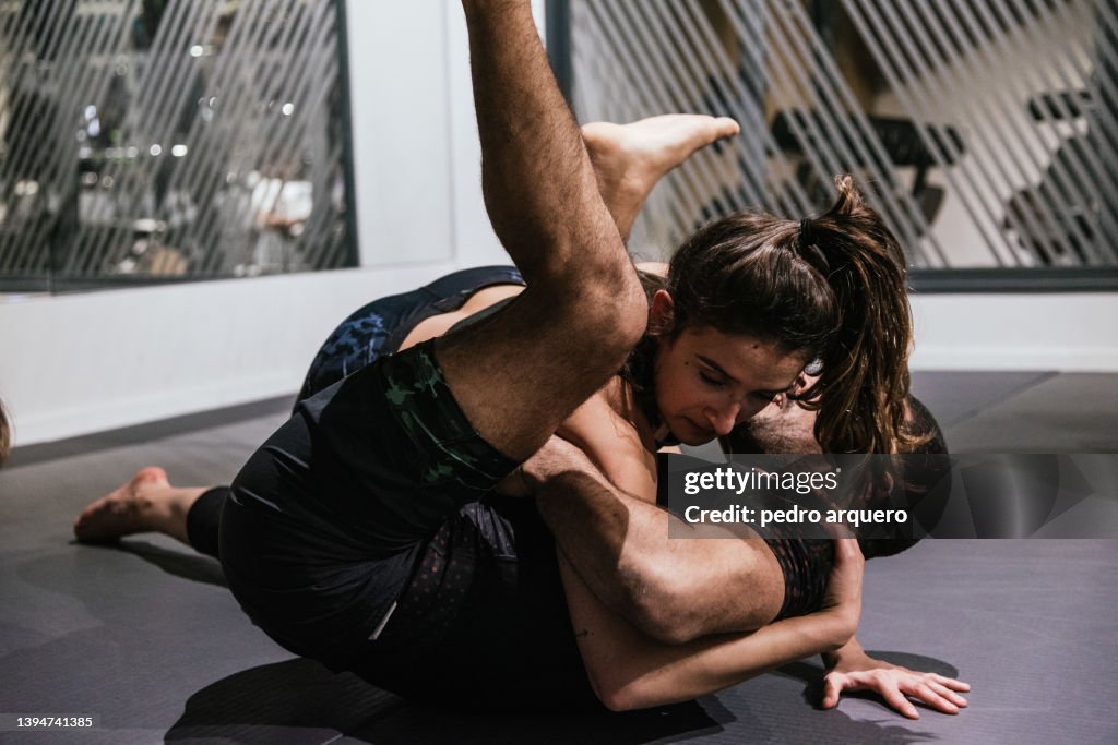 Jiu jitsu coach practicing and teaching techniques to his students