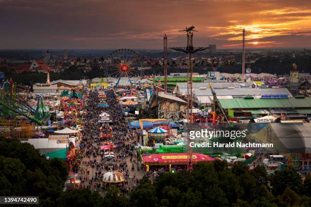 beer fest overview at sunset, munich, bavaria, germany - ビアホール ストックフォトと画像