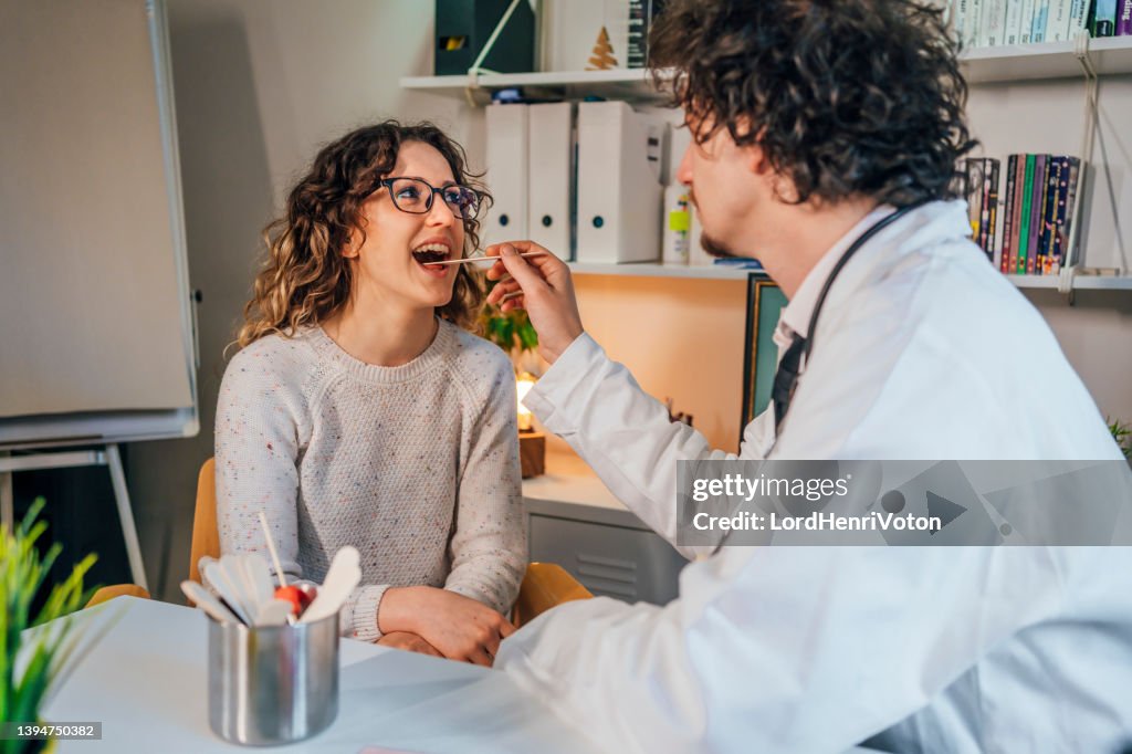Doctor taking a throat swab