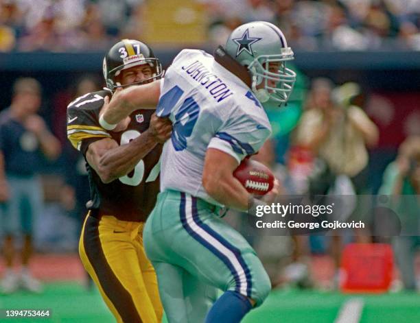 Fullback Daryl Johnston of the Dallas Cowboys runs with the football as he fights of the tackle by cornerback Carnell Lake of the Pittsburgh Steelers...