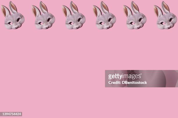 hare rabbit masks pattern with hard shadow. on top, on pink background. disguise, masquerade, carnival, easter and fun concept. - easter bunny mask stockfoto's en -beelden