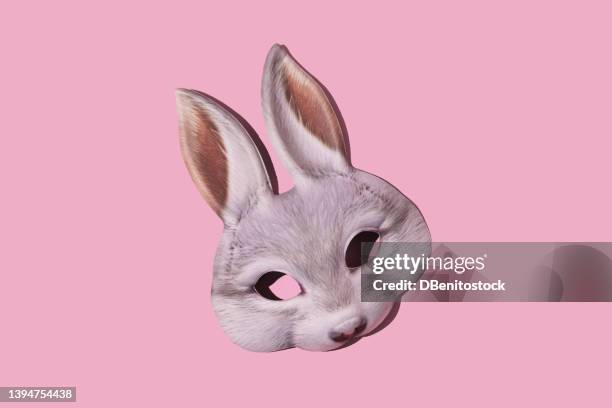 hare rabbit mask with hard shadow on pink background. disguise, masquerade, carnival, easter and fun concept. - mask disguise stockfoto's en -beelden