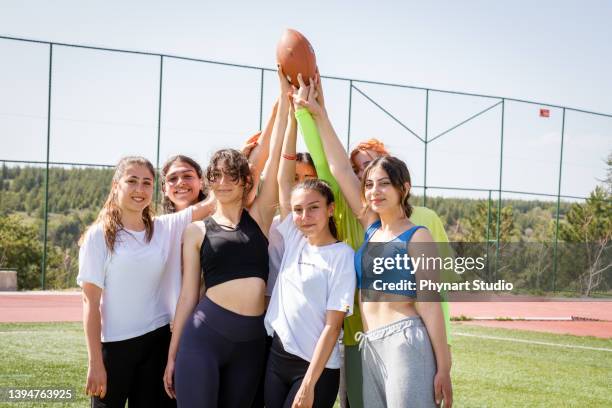 portrait of high school sport team members - girl american football player stock pictures, royalty-free photos & images