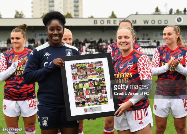 Anita Asante of Aston Villa is presented with a commemorative picture by Kim Little of Arsenal in recognition of her upcoming retirement at the end...