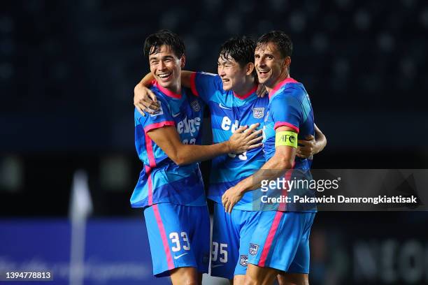 Sean Tse, Shinichi Chan and Helio Goncalves of Kitchee celebrate as they have gone through to the knockout stage following the 2-2 draw in during the...