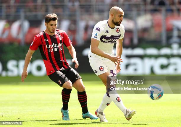 Sofyan Amrabat of Fiorentina is challenged by Brahim Diaz of AC Milan during the Serie A match between AC Milan and ACF Fiorentina at Stadio Giuseppe...