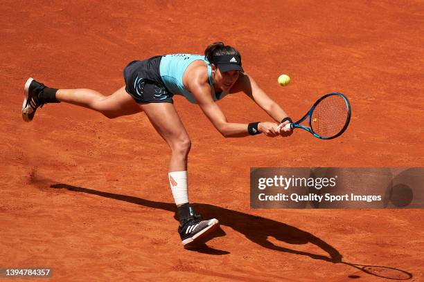 Garbine Muguruza of Spain returns a ball to Anhelina Kalinina of Ukraine during Day Four of Mutua Madrid Open at La Caja Magica on May 01, 2022 in...