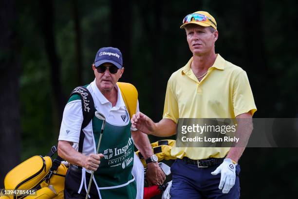 John Senden of Australia is handed his putter on the first hole during the final round of the Insperity Invitational at The Woodlands Golf Club on...