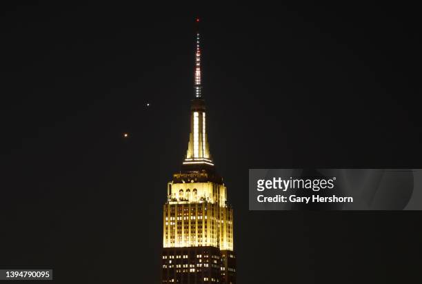 Planets Venus and Jupiter rise together in the pre-dawn sky behind the Empire State Building in New York City on May 1 as seen from Hoboken, New...