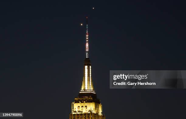 Planets Venus and Jupiter rise together in the pre-dawn sky behind the Empire State Building in New York City on May 1 as seen from Hoboken, New...