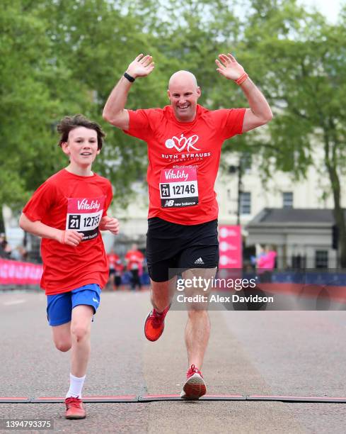 Sir Andrew Strauss finishes the Ruth Strauss Foundation run with son Luca during the Vitality Westminster Mile on May 01, 2022 in London, England.