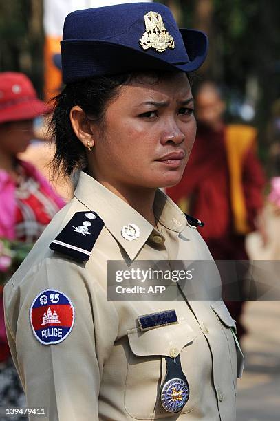 Cambodian policewoman stand guards during a ceremony at Oddong mountain in Kandal province, some 40 kilometers north of Phnom Penh on February 7,...