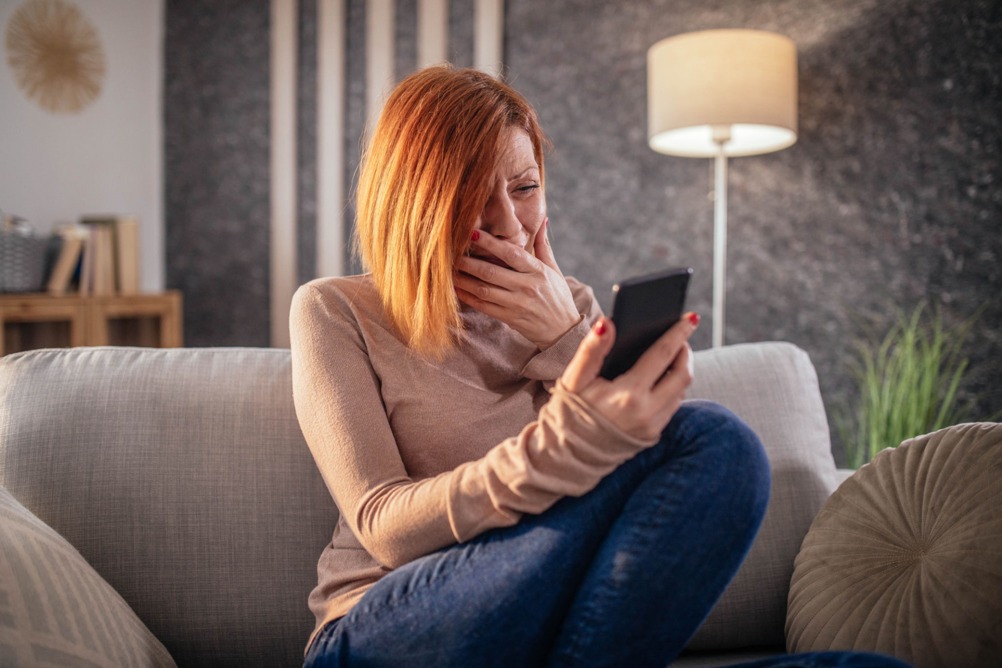 depressed woman at home using smartphone and laptop depressed woman at home using smartphone and laptop