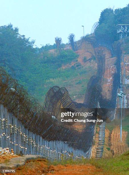 The barbed wire fences along the mine-strewn Demilitarized Zone between the two Koreas is shown September 19, 2002 in Paju, north of Seoul, South...