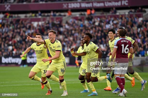 Rob Holding of Arsenal celebrates scoring their side's first goal with teammates during the Premier League match between West Ham United and Arsenal...